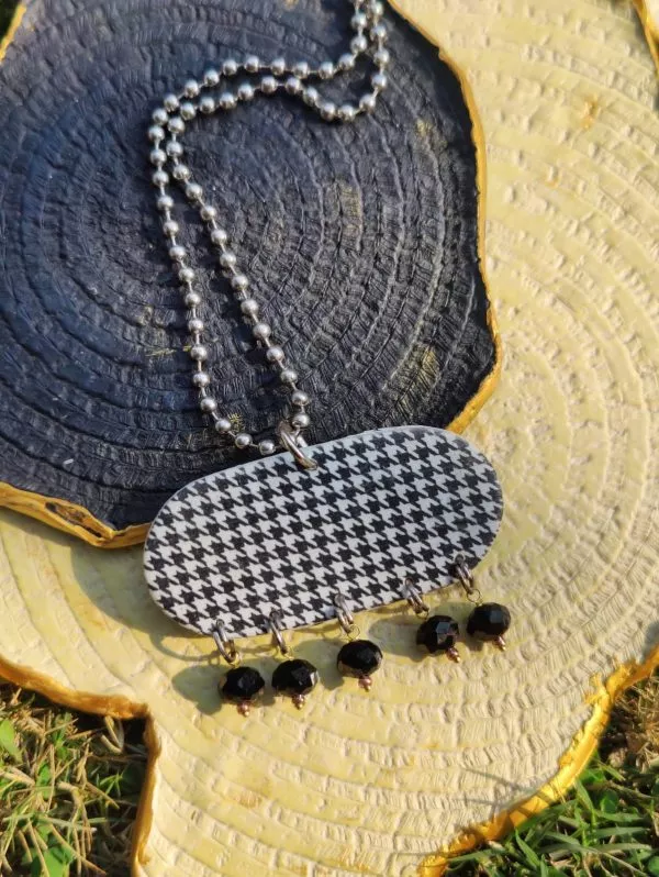 Black and white long houndstooth necklace with beaded chain is a universally-loved style.