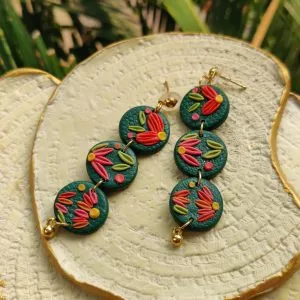 Round earrings design is a fun way to add color to your look. 3 small rounds with a dark green base, embellished with multi-colored intricate style to work its magic on you.